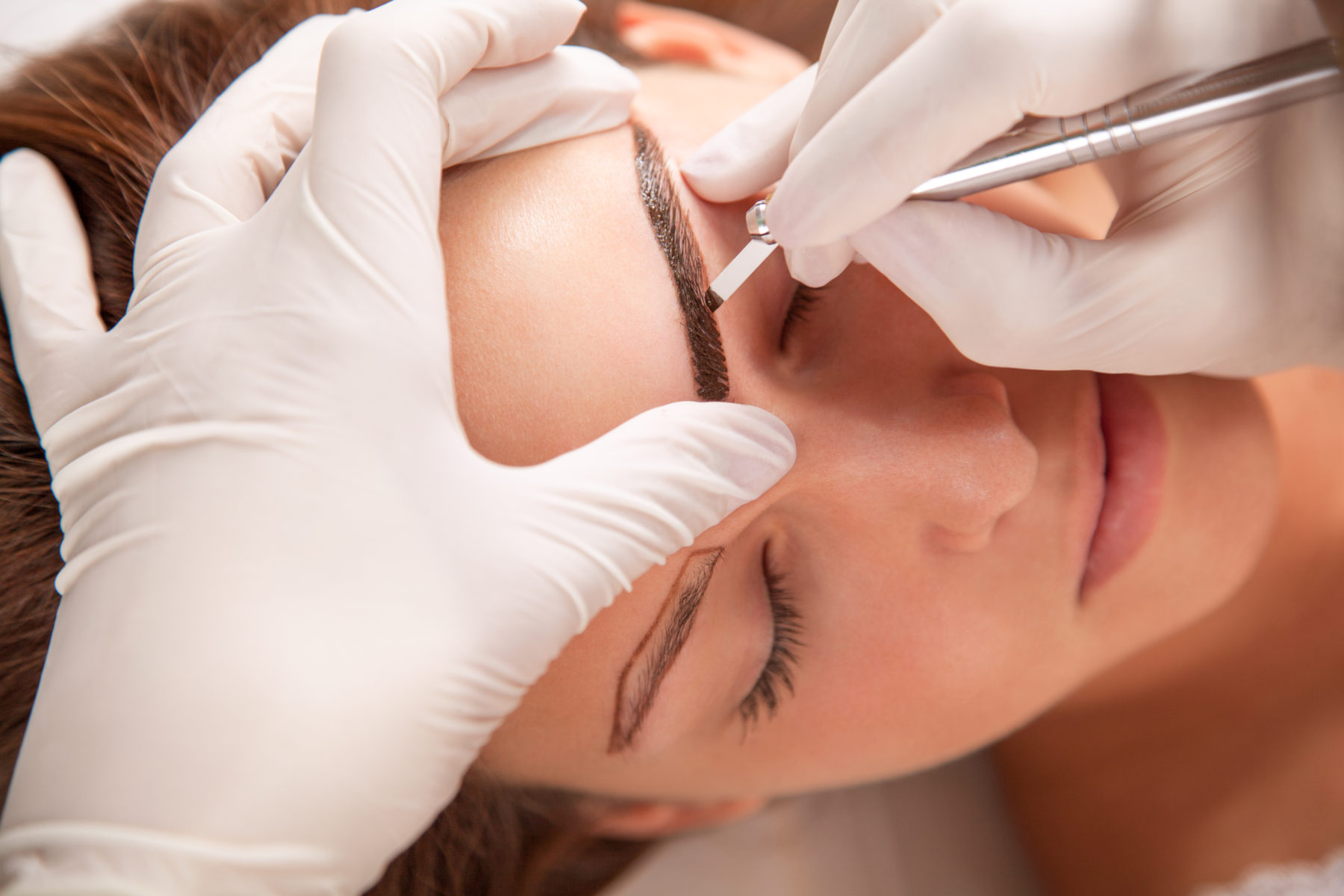 Beautiful woman in beauty slon on eyebrow makeup treatment